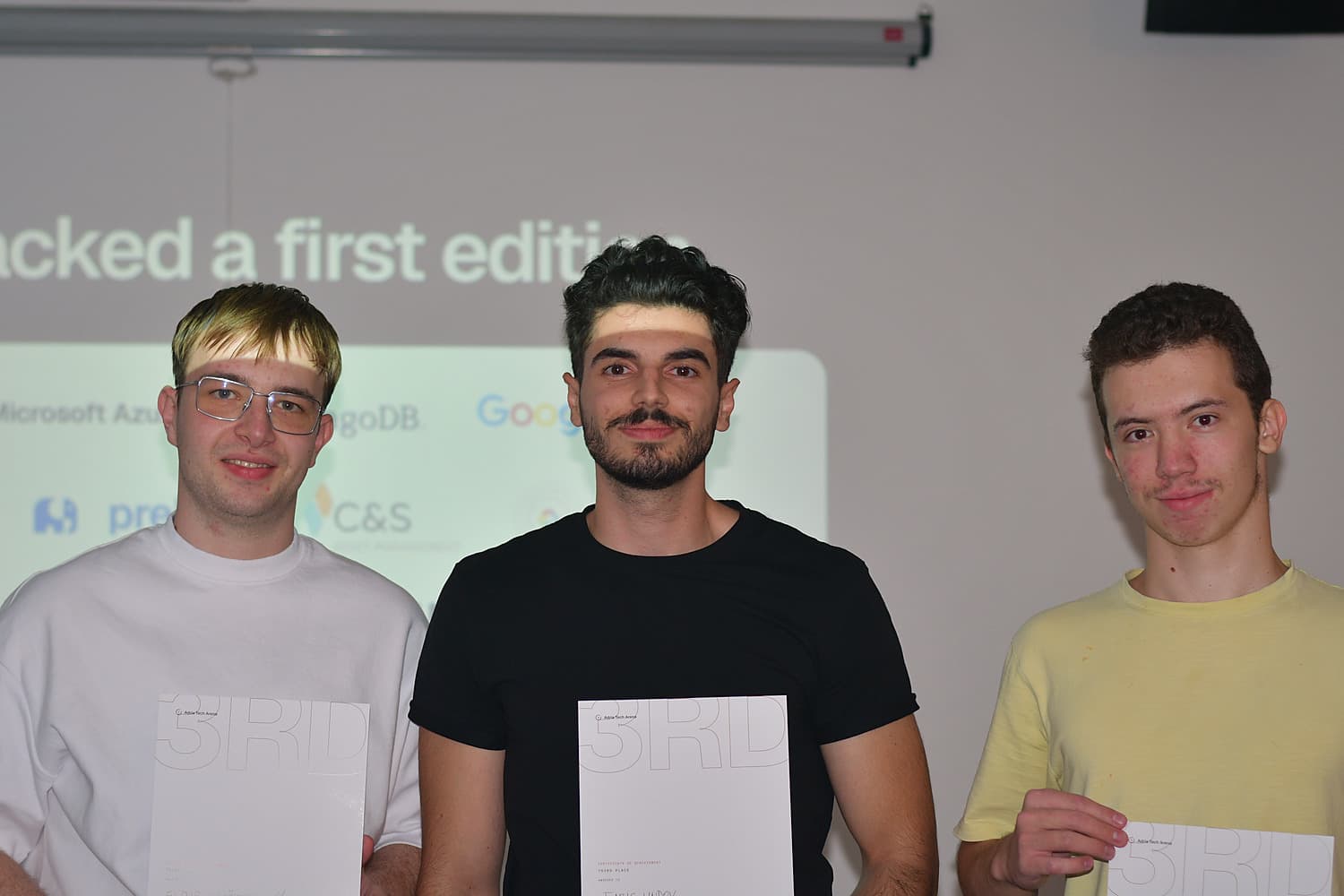 The three-person AmopAI team holding their third-place certificates at the Adria Hack Sarajevo award ceremony.