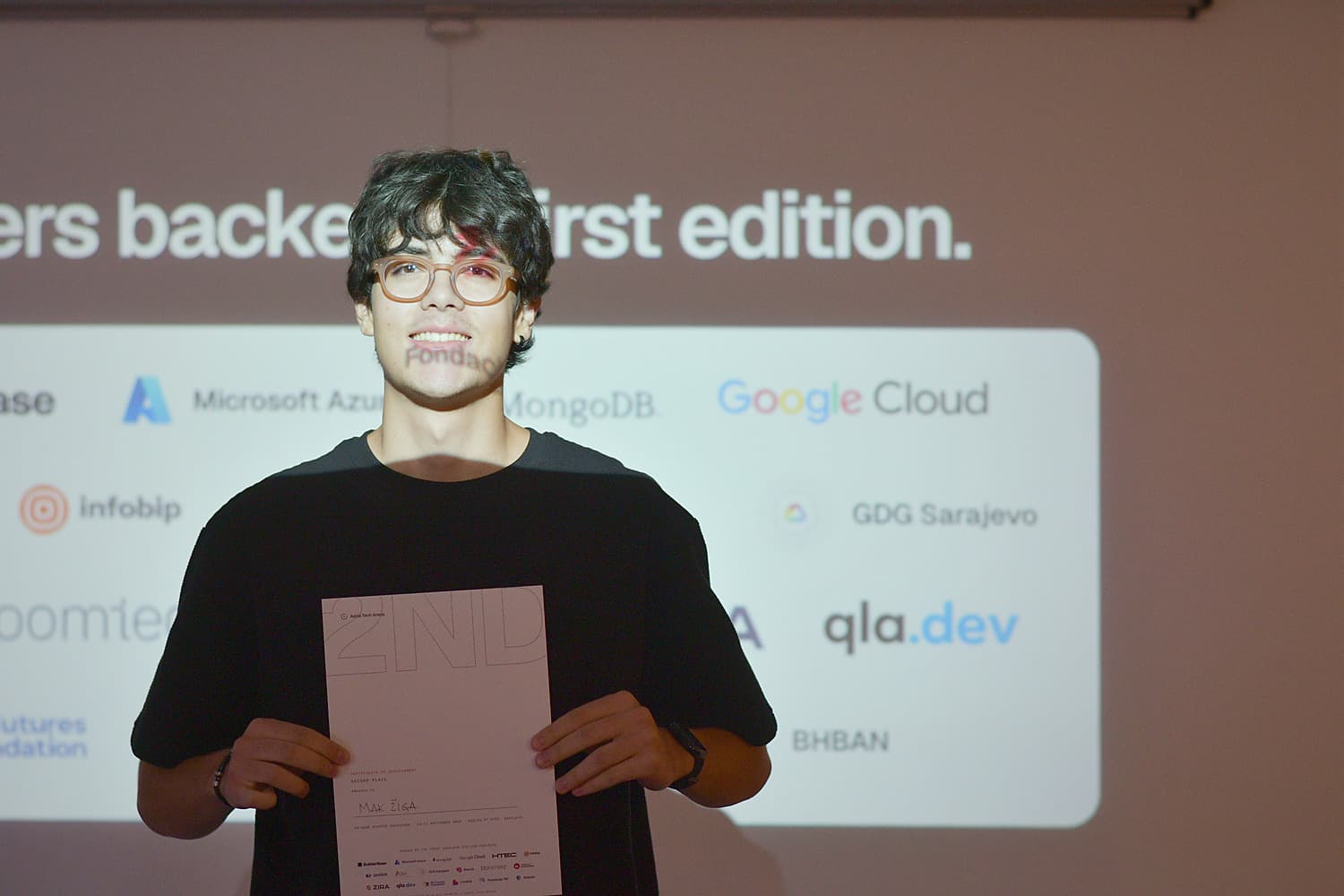 A member of the Quasr team holding the second-place certificate at the Adria Hack Sarajevo award ceremony.